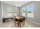 Well-lit dining room with a chandelier and four large windows at 5501 N 15Th St, Tampa, FL 33610