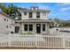 Charming two-story home featuring a white picket fence, gray accents, and a welcoming front porch at 5501 N 15Th St, Tampa, FL 33610