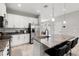 Bright kitchen with stainless steel appliances, granite countertops, and island with seating at 5501 N 15Th St, Tampa, FL 33610