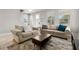Comfortable living room with sofas, a coffee table, and large windows providing natural light at 5501 N 15Th St, Tampa, FL 33610