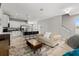 Bright and airy living space with sofas, a coffee table, and an open layout connecting to a modern kitchen at 5501 N 15Th St, Tampa, FL 33610