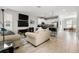 Spacious living room with tile floors, modern furniture, and an open floor plan leading to the kitchen at 5501 N 15Th St, Tampa, FL 33610