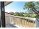 Balcony view overlooking lush greenery and a pond on a bright sunny day at 5559 Escondida S Blvd, St Petersburg, FL 33715