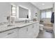 Spa-like bathroom with a double vanity, modern lighting, and frameless glass shower at 5559 Escondida S Blvd, St Petersburg, FL 33715