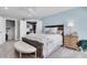 Light-filled bedroom includes a king bed, walk-in closet, and neutral paint at 5559 Escondida S Blvd, St Petersburg, FL 33715