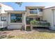 Charming home featuring a private balcony and wooden deck with lush landscaping at 5559 Escondida S Blvd, St Petersburg, FL 33715