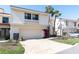 Charming townhome featuring a two-car garage, well-kept landscaping, and a classic stucco and siding exterior at 5559 Escondida S Blvd, St Petersburg, FL 33715