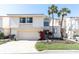 Charming two-story home with a well-manicured lawn and a two-car garage at 5559 Escondida S Blvd, St Petersburg, FL 33715