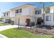 Charming townhome featuring a two-car garage, well-kept landscaping, and a classic stucco and siding exterior at 5559 Escondida S Blvd, St Petersburg, FL 33715