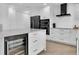 Modern kitchen with a wine fridge, sleek appliances, subway tile backsplash, and plenty of cabinet space at 5559 Escondida S Blvd, St Petersburg, FL 33715