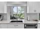 Kitchen area with granite countertops, stainless steel appliances, and a window overlooking the yard at 5559 Escondida S Blvd, St Petersburg, FL 33715