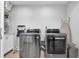 Well-equipped laundry room with modern washer and dryer units and storage space at 5559 Escondida S Blvd, St Petersburg, FL 33715