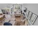 Bright living room boasts a fireplace, hardwood floors, neutral decor, and sliding glass doors to the deck at 5559 Escondida S Blvd, St Petersburg, FL 33715