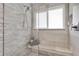 Modern shower with textured tile, built-in bench, and a convenient window at 5559 Escondida S Blvd, St Petersburg, FL 33715