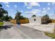 New wood fence along side of the home with concrete parking pad at 5601 16Th N St, St Petersburg, FL 33703