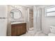 Updated bathroom with granite countertop, a shower with tile surround, and updated fixtures at 5601 16Th N St, St Petersburg, FL 33703