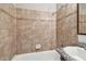 Tiled bath and shower with granite countertop and dark wooden vanity at 5601 16Th N St, St Petersburg, FL 33703