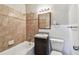 Updated bathroom with granite counter, white wainscoting, and tiled tub/shower at 5601 16Th N St, St Petersburg, FL 33703