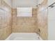 This bathroom features tiled shower and tub enclosure and white tub at 5601 16Th N St, St Petersburg, FL 33703