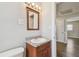 Bathroom featuring a granite vanity, wood cabinet, and view into bedroom at 5601 16Th N St, St Petersburg, FL 33703