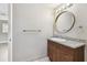 Bathroom with granite countertop, a round mirror, and updated fixtures and accessories at 5601 16Th N St, St Petersburg, FL 33703