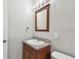 Bathroom features a wooden framed mirror and granite countertop on a traditional vanity at 5601 16Th N St, St Petersburg, FL 33703
