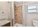A bathroom featuring a shower with tile surround, granite counters, and updated fixtures at 5601 16Th N St, St Petersburg, FL 33703