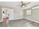 Light-filled bedroom with vinyl floors, a ceiling fan, and a mini split air conditioning unit at 5601 16Th N St, St Petersburg, FL 33703