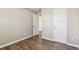Spacious bedroom with wood-look flooring, neutral walls, and white trim at 5601 16Th N St, St Petersburg, FL 33703