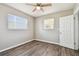 Light-filled bedroom with hardwood floors, two windows and a ceiling fan at 5601 16Th N St, St Petersburg, FL 33703