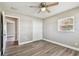 This bedroom includes a closet and light woodgrain-look floors with a hall entry in view at 5601 16Th N St, St Petersburg, FL 33703