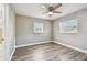 This bedroom has two windows, light woodgrain-look floors and entry to an attached bathroom at 5601 16Th N St, St Petersburg, FL 33703