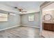 Bright bedroom featuring vinyl floors, a ceiling fan, and an ensuite bathroom with modern finishes at 5601 16Th N St, St Petersburg, FL 33703