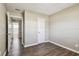 Bedroom with wood-look flooring, light gray walls, and an ensuite bathroom at 5601 16Th N St, St Petersburg, FL 33703