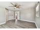 Spacious bedroom featuring a ceiling fan, vinyl floors, a closet, and an ensuite bathroom at 5601 16Th N St, St Petersburg, FL 33703