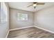 This bedroom features two large windows for ample natural light and light woodgrain-look floors at 5601 16Th N St, St Petersburg, FL 33703
