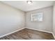 Empty bedroom with neutral walls, vinyl floors, and window providing natural light at 5601 16Th N St, St Petersburg, FL 33703