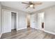 This bedroom features a closet, light woodgrain-look floors and a view to an attached bathroom at 5601 16Th N St, St Petersburg, FL 33703