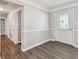 Bright entryway featuring wood-look flooring and a white front door with decorative glass at 5601 16Th N St, St Petersburg, FL 33703