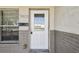 A close up of the front door with sidelight window at 5601 16Th N St, St Petersburg, FL 33703