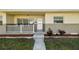 Inviting front porch with white railings and manicured flower beds at 5601 16Th N St, St Petersburg, FL 33703