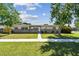 Single-story home boasting a manicured lawn and tidy landscaping at 5601 16Th N St, St Petersburg, FL 33703