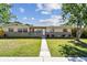 Traditional single-story home with a walkway leading to the front door at 5601 16Th N St, St Petersburg, FL 33703