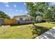 Well-maintained single-story home with a vibrant lawn and mature tree at 5601 16Th N St, St Petersburg, FL 33703