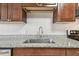 Close-up of the kitchen sink, faucet, and granite countertops at 5601 16Th N St, St Petersburg, FL 33703