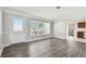 Bright living room with new vinyl floors, fresh paint, and large windows letting in plenty of natural light at 5601 16Th N St, St Petersburg, FL 33703