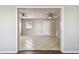 Light-filled living room with tile flooring, ceiling fans, and neutral paint creating a comfortable space at 5601 16Th N St, St Petersburg, FL 33703