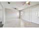 Spacious living room featuring tile floors, ceiling fans, and natural light creating a cozy atmosphere at 5601 16Th N St, St Petersburg, FL 33703