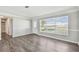 Bright living room with new vinyl floors, fresh paint, and large windows letting in plenty of natural light at 5601 16Th N St, St Petersburg, FL 33703