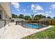 Backyard pool enclosed with black safety fence and brick paver patio at 5601 16Th N St, St Petersburg, FL 33703